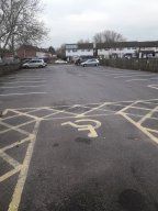 View of car park, including accessible parking.
