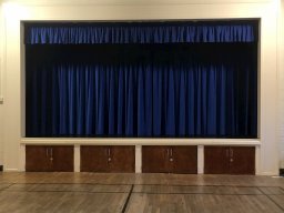 View onto stage, curtains down.